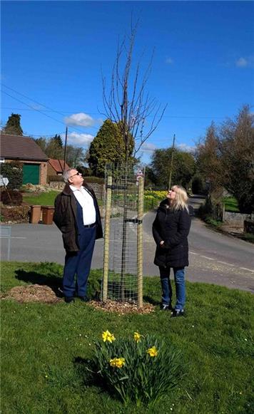 BPC Chair Penny Twaites and Councillor Andrew Bowles inspect the new Purple Leaved Plum tree. - Tree projects in Bredgar